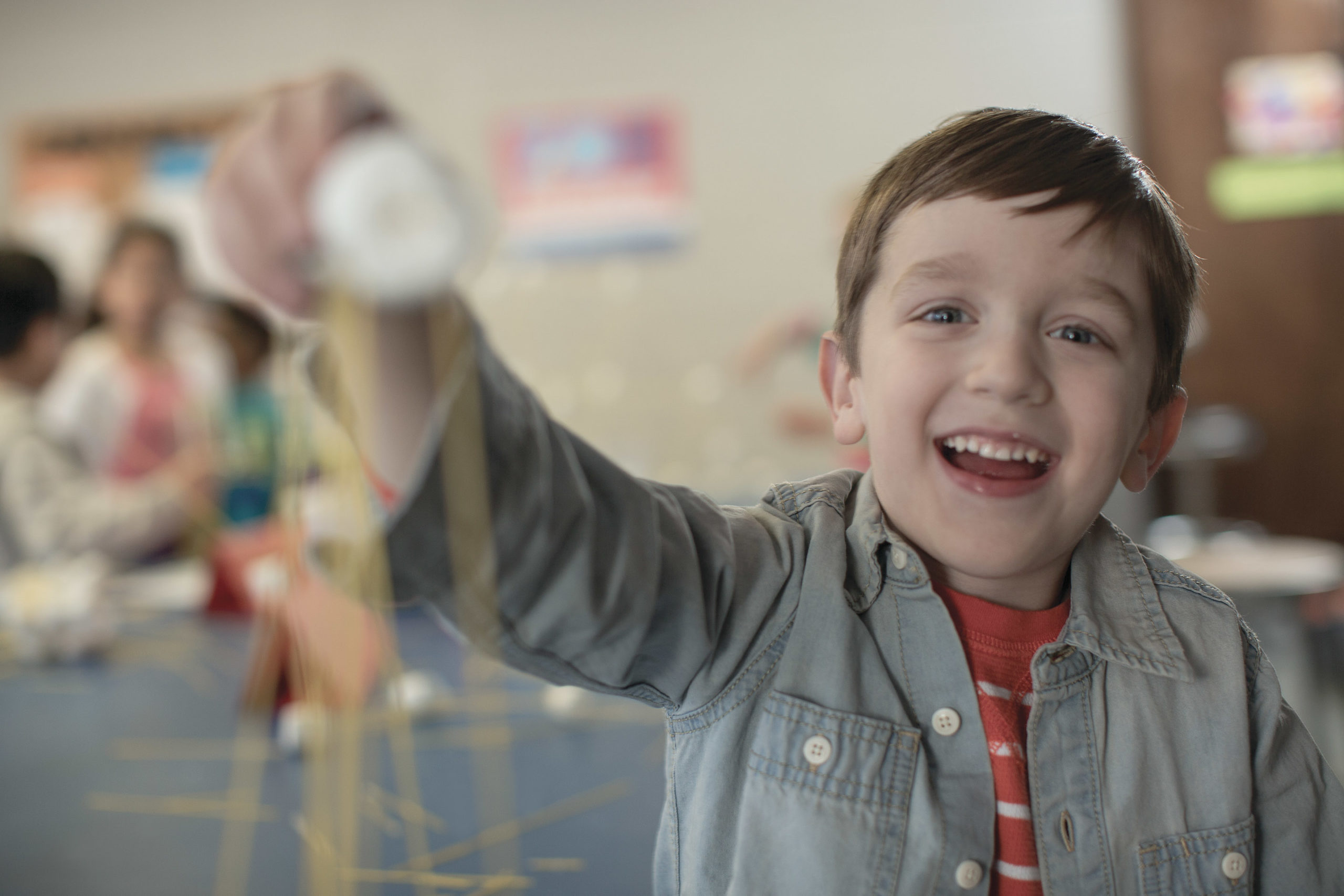 Young boy smiling holding toy