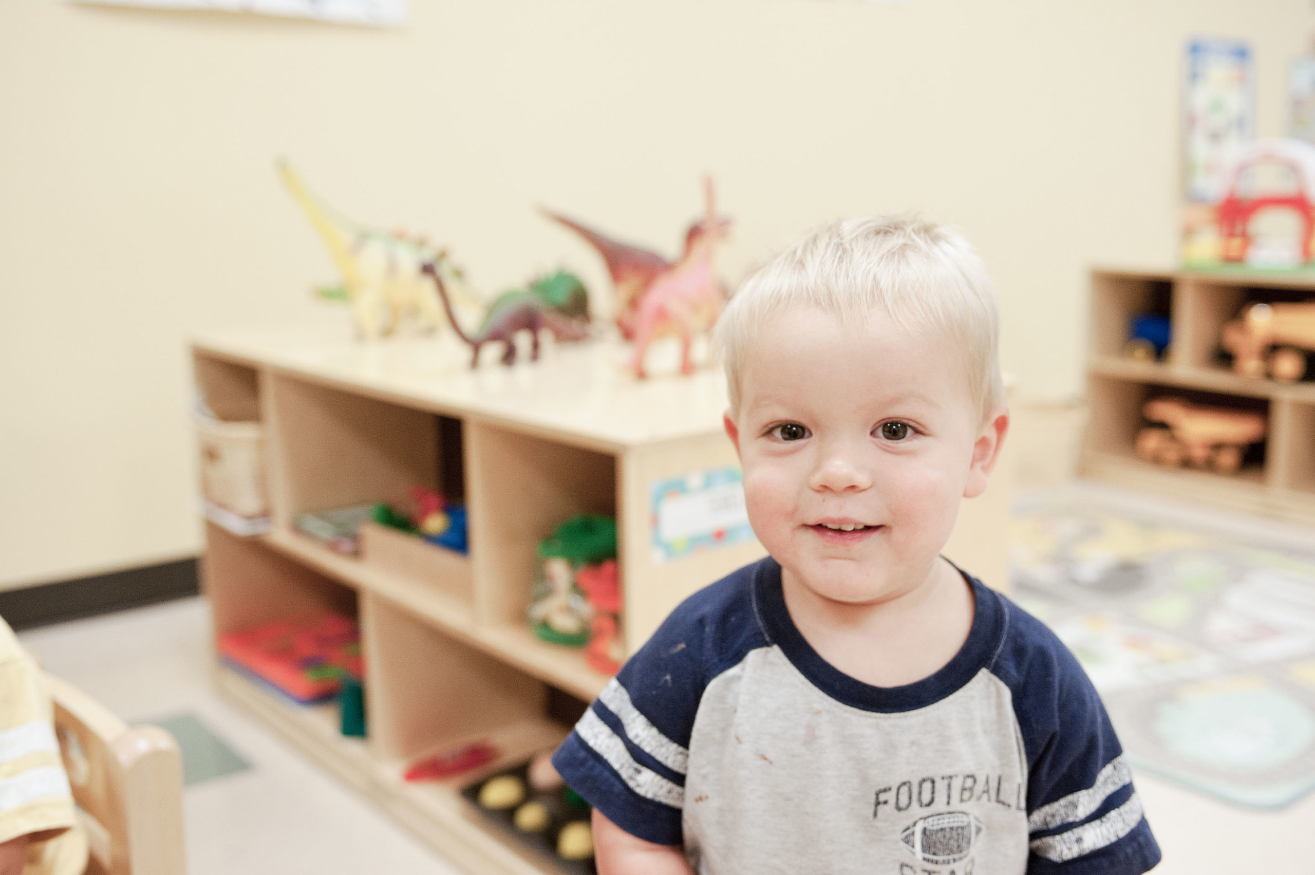 Toddler smiling in classroom