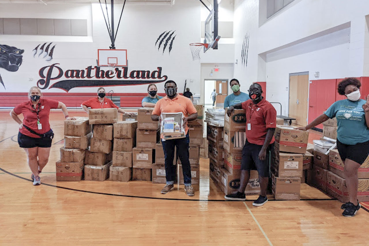 YMCA staff standing by donated boxes