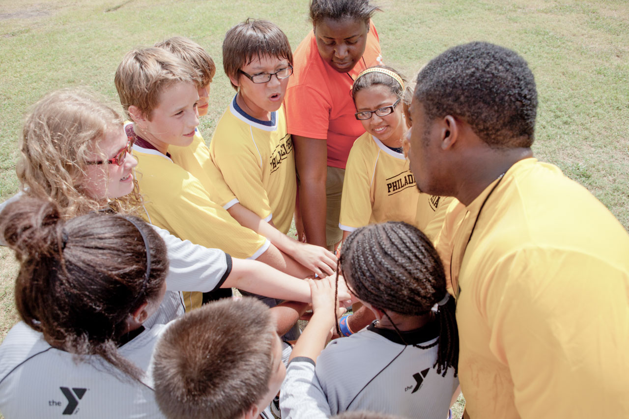 A ymca sports team in a huddle