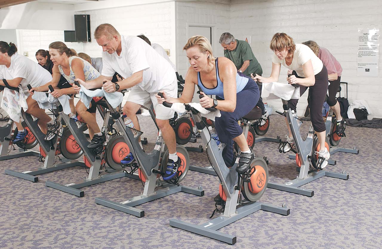 group of people doing a cycling class