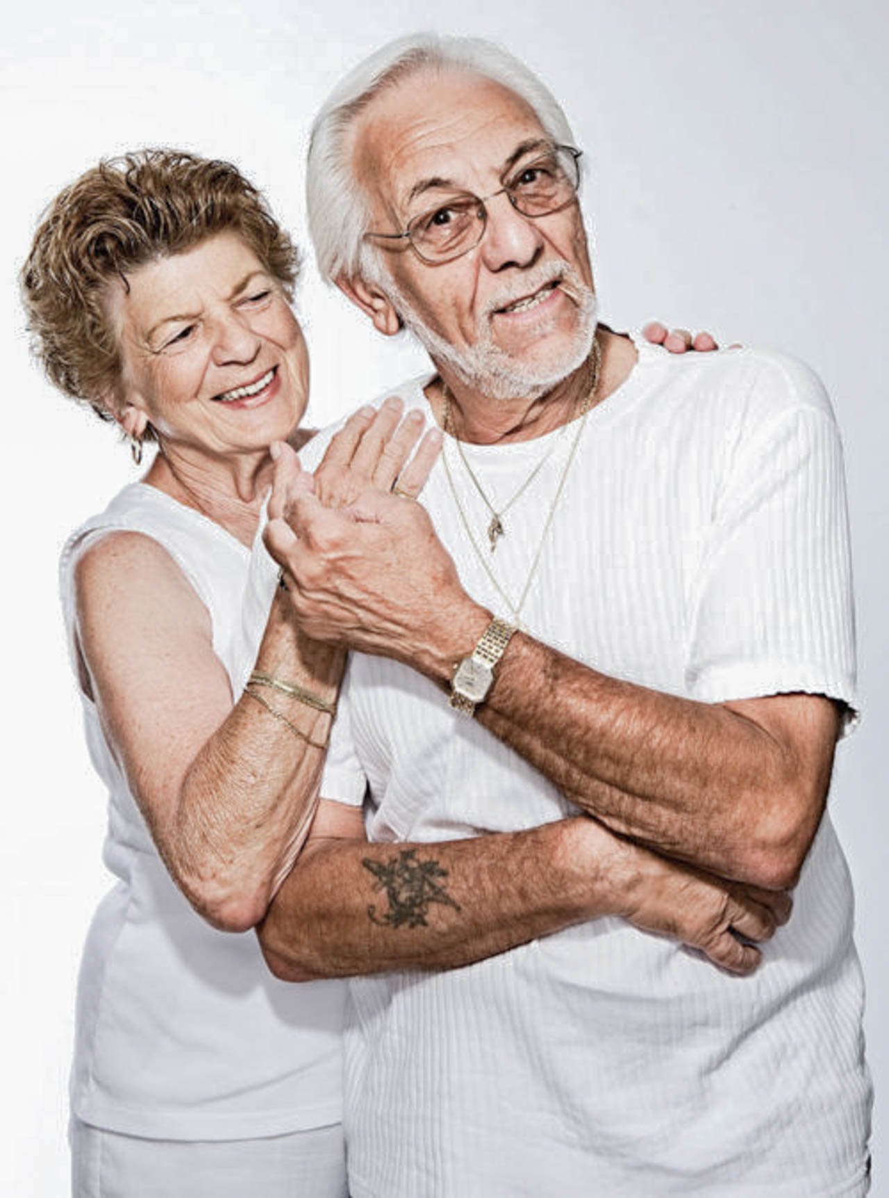 elderly couple grasping hands