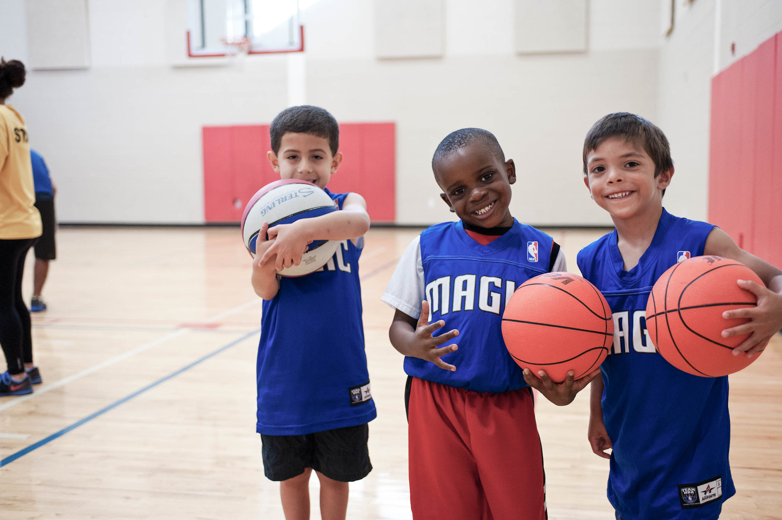 ymca-houston-sports-basketball-header Youth basketball team holding basketballs
