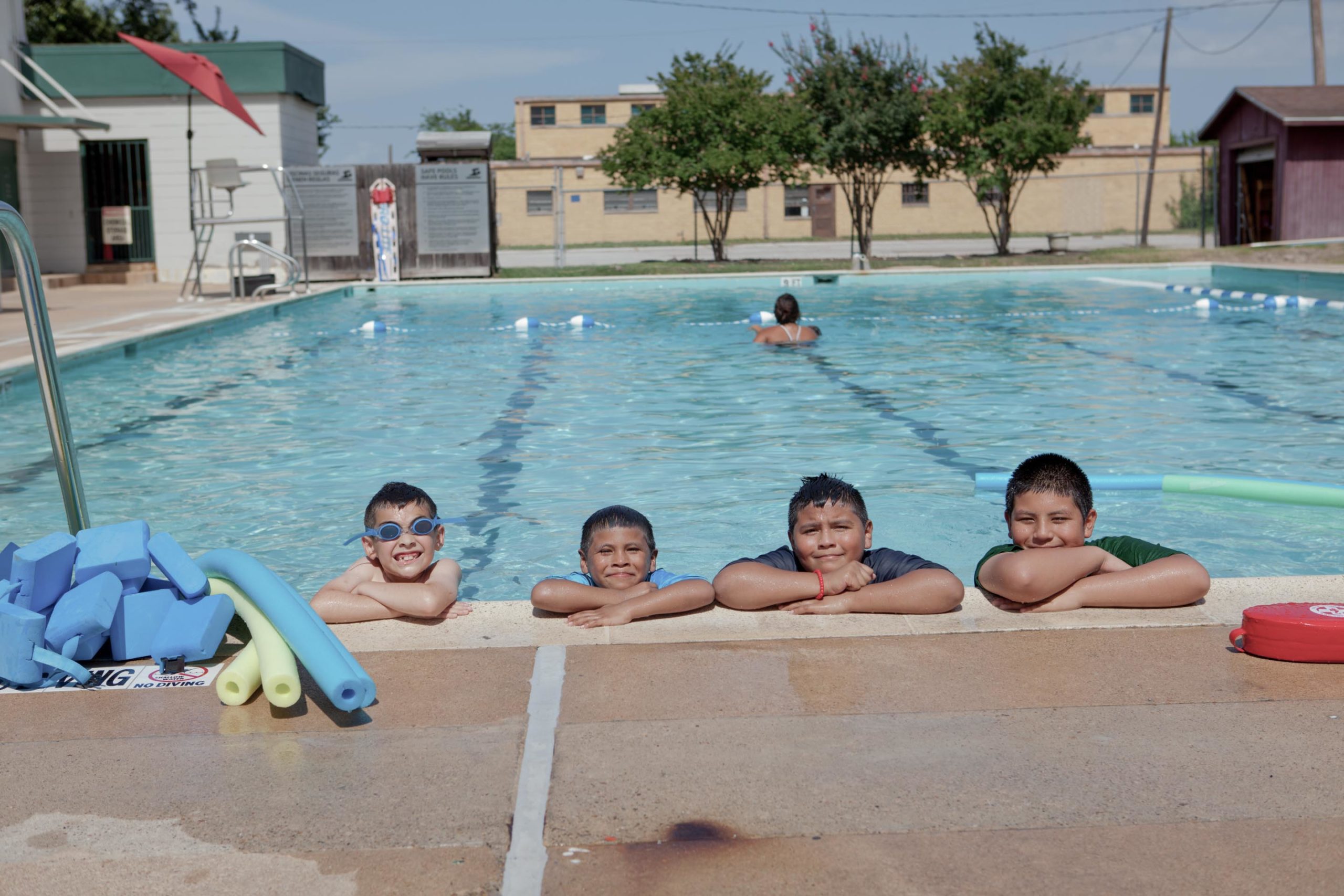 Kids propping head up on pool side