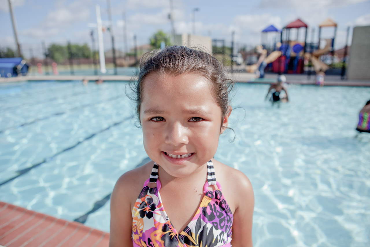 Closeup of a smiling young girl at the pool