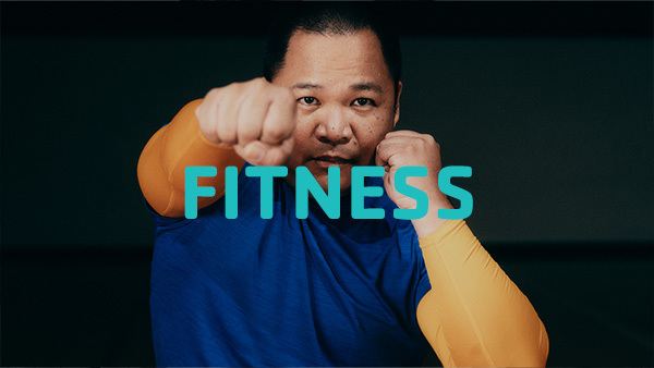Fitness text with man on boxing stance in the background